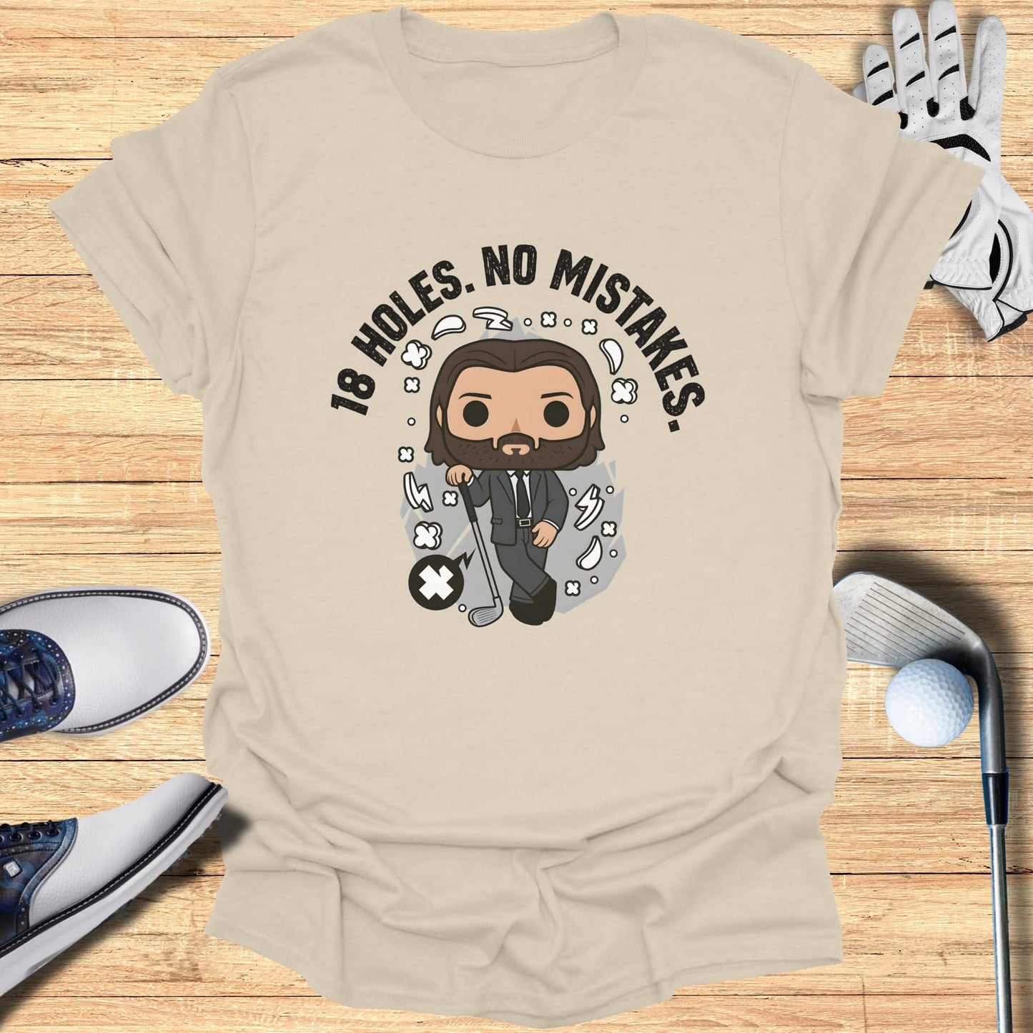 T-shirt with cartoon man, golf club, and text "18 HOLES. NO MISTAKES."