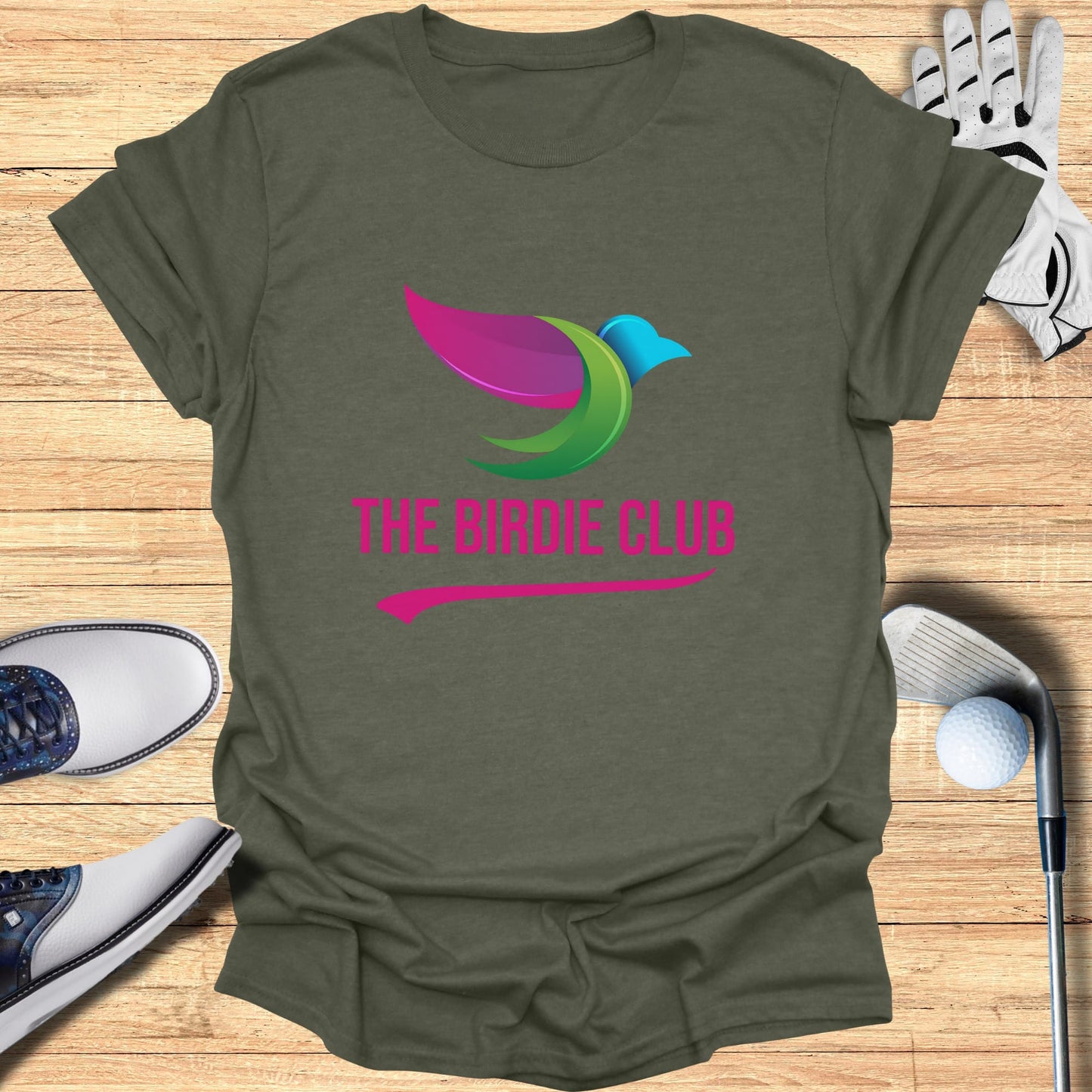 Olive green t-shirt with "The Birdie Club" logo and golf accessories.