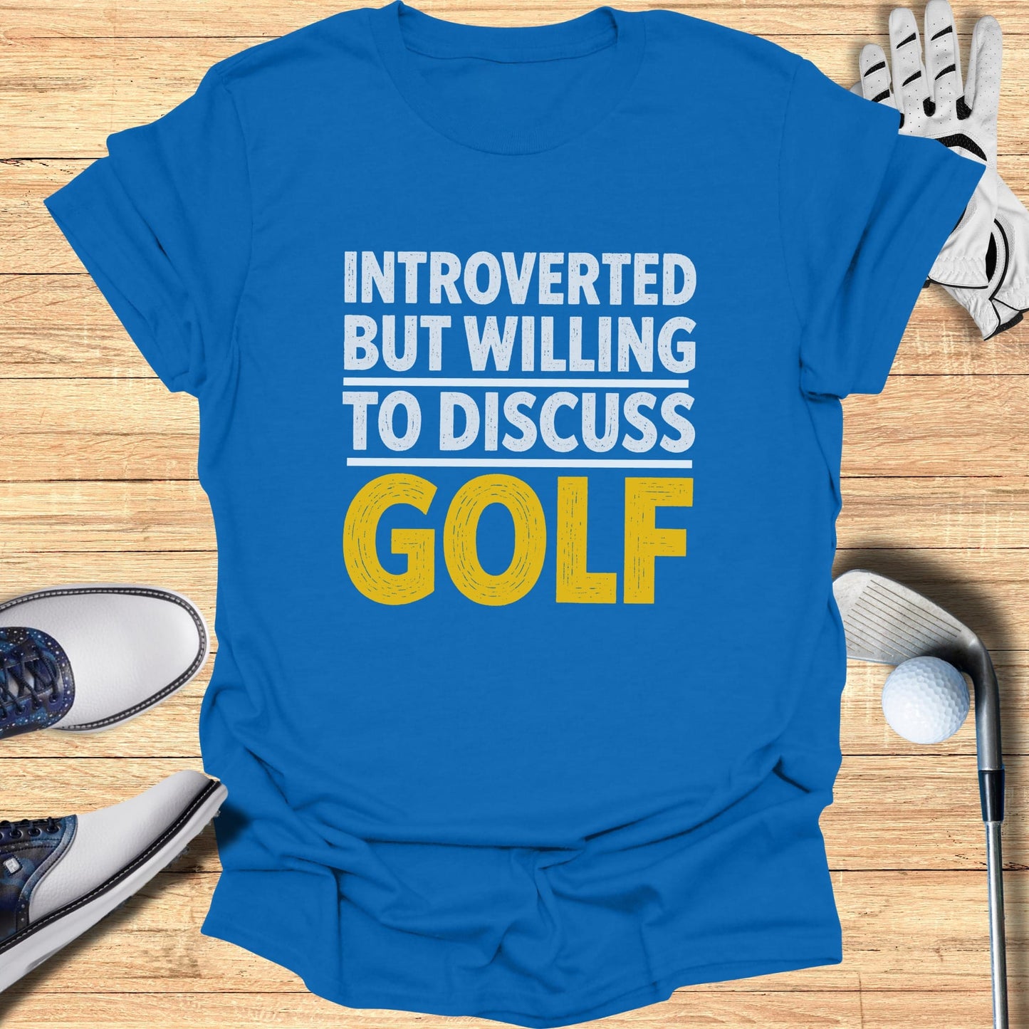 Blue t-shirt with yellow text "INTROVERTED BUT WILLING TO DISCUSS GOLF".